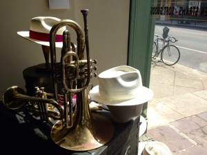 The natural pairing of style and sound in a New Orleans hat shop window.