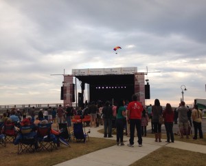 An ultralight flies over the Hancock Bank stage where The Revivalists close out Bay BridgeFest Sunday evening.