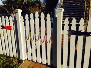 Some whimsical accessories just added to a neighborhood fence.